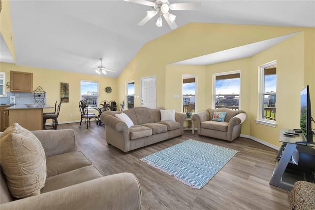 4023 Grayson Dr, Galveston, TX 77554 - living room featuring a ceiling fan, lofted ceiling, light wood-type flooring, and baseboards