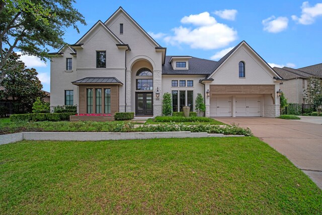 23323 Two Harbors Glen St, Katy, TX 77494 - french provincial home with brick siding, concrete driveway, a front yard, and french doors