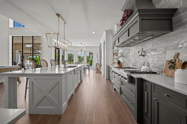 23323 Two Harbors Glen St, Katy, TX 77494 - kitchen with appliances with stainless steel finishes, backsplash, a chandelier, dark wood-style flooring, and recessed lighting