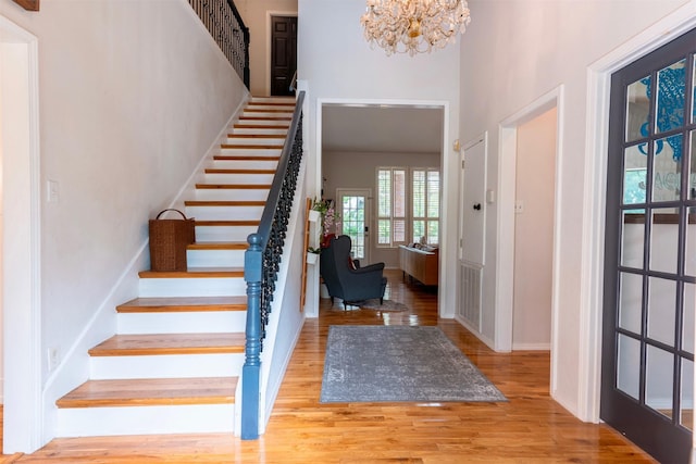 5343 Appleblossom Ln, Friendswood, TX 77546 - foyer entrance with wood finished floors, stairway, a high ceiling, and a chandelier