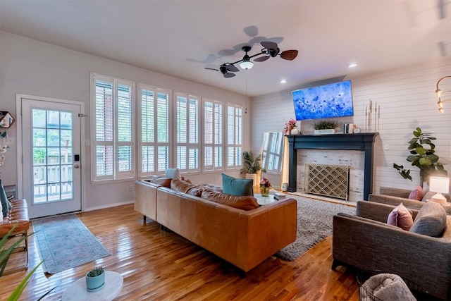 5343 Appleblossom Ln, Friendswood, TX 77546 - living area featuring wood finished floors, a ceiling fan, recessed lighting, and a fireplace