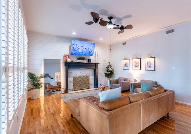 5343 Appleblossom Ln, Friendswood, TX 77546 - living room featuring a ceiling fan, wood finished floors, recessed lighting, and a tiled fireplace