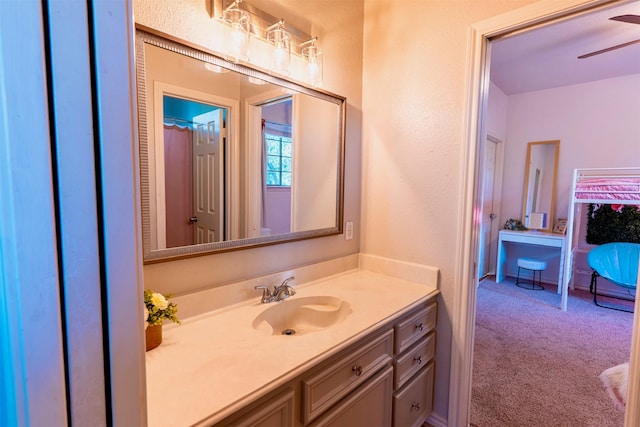 5343 Appleblossom Ln, Friendswood, TX 77546 - bathroom with vanity, a ceiling fan, and a textured wall