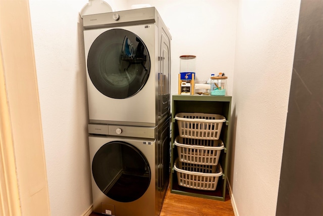 5343 Appleblossom Ln, Friendswood, TX 77546 - laundry area with stacked washer / drying machine and wood finished floors