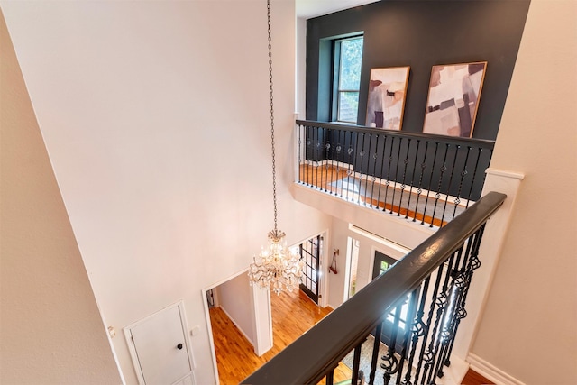 5343 Appleblossom Ln, Friendswood, TX 77546 - stairway with a towering ceiling, wood finished floors, and a chandelier