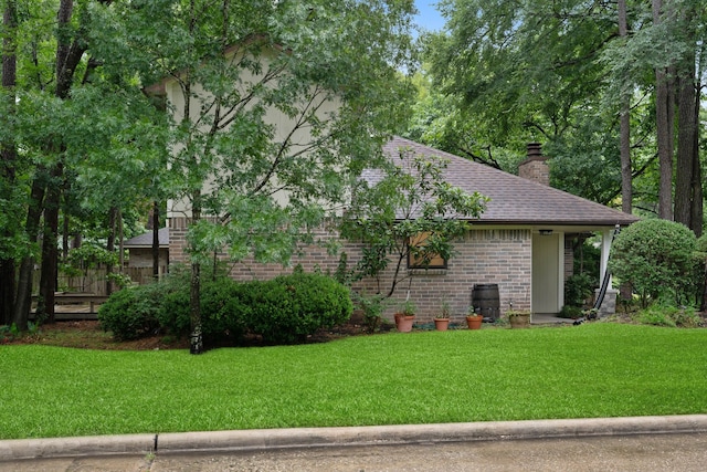 71 Timberspire Ln, The Woodlands, TX 77380 - view of side of property with brick siding, a chimney, and a shingled roof