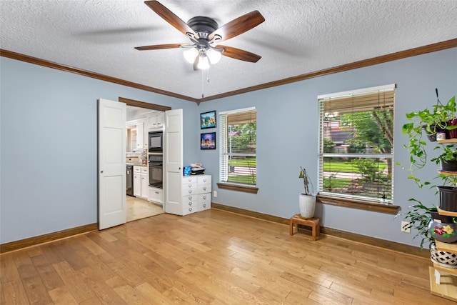 20131 Magnolia Bend Dr, Humble, TX 77346 - spare room featuring a ceiling fan, crown molding, a textured ceiling, light wood finished floors, and baseboards