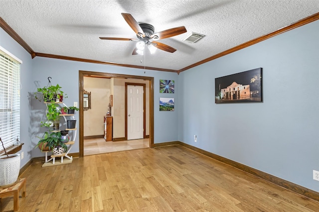 20131 Magnolia Bend Dr, Humble, TX 77346 - unfurnished room featuring light wood-style flooring, a ceiling fan, a textured ceiling, ornamental molding, and baseboards