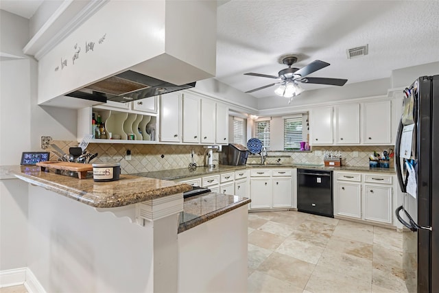 20131 Magnolia Bend Dr, Humble, TX 77346 - kitchen with black appliances, a peninsula, wall chimney range hood, white cabinetry, and tasteful backsplash