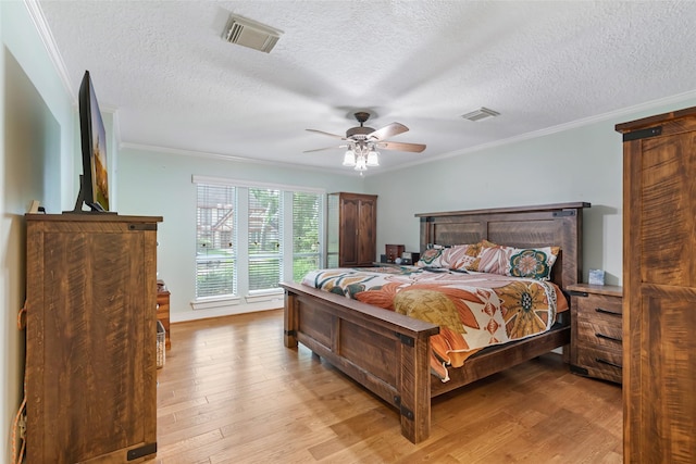 20131 Magnolia Bend Dr, Humble, TX 77346 - bedroom featuring ornamental molding, light wood finished floors, a textured ceiling, and a ceiling fan