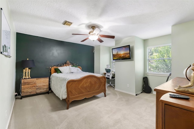 20131 Magnolia Bend Dr, Humble, TX 77346 - bedroom featuring baseboards, light colored carpet, a ceiling fan, and a textured ceiling