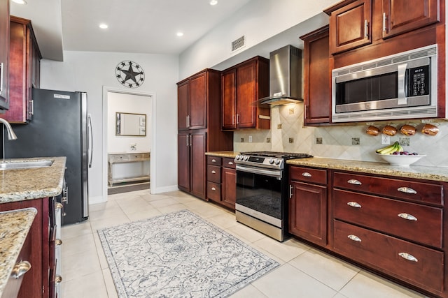 9123 Kapri Ln, Houston, TX 77025 - kitchen featuring appliances with stainless steel finishes, wall chimney exhaust hood, dark brown cabinets, decorative backsplash, and recessed lighting