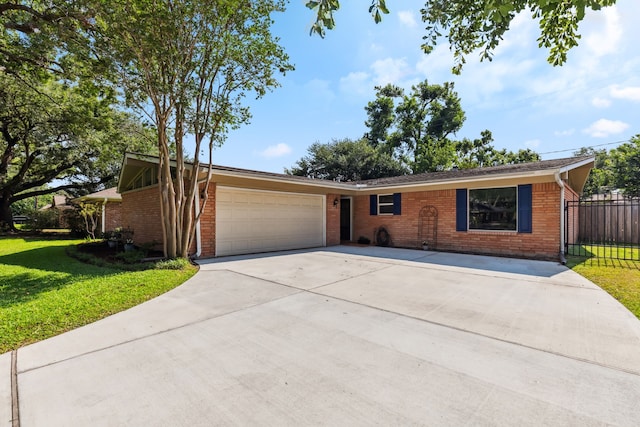 9123 Kapri Ln, Houston, TX 77025 - view of front of home with brick siding, a garage, and driveway