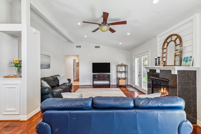 9123 Kapri Ln, Houston, TX 77025 - living room featuring vaulted ceiling, ceiling fan, wood finished floors, a fireplace, and baseboards