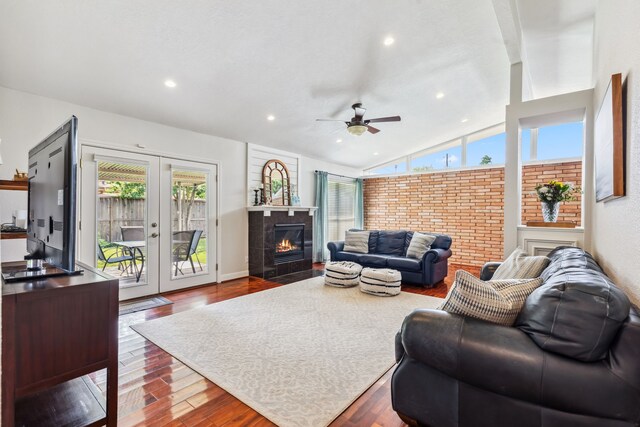 9123 Kapri Ln, Houston, TX 77025 - living room with wood finished floors, vaulted ceiling, ceiling fan, a tile fireplace, and recessed lighting