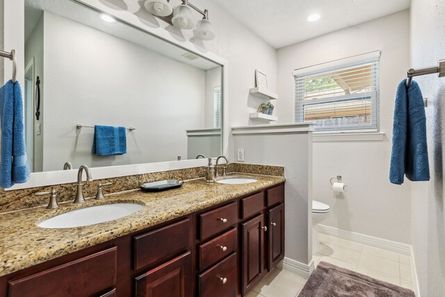 9123 Kapri Ln, Houston, TX 77025 - full bath featuring toilet, double vanity, tile patterned floors, and baseboards