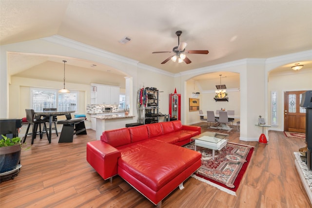20107 Black Canyon Dr, Katy, TX 77450 - living room with arched walkways, ceiling fan, and wood finished floors