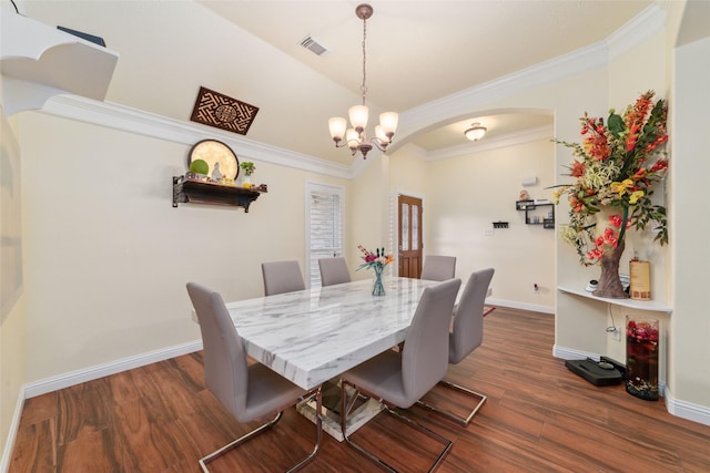 20107 Black Canyon Dr, Katy, TX 77450 - dining room featuring arched walkways, dark wood-type flooring, baseboards, ornamental molding, and a chandelier