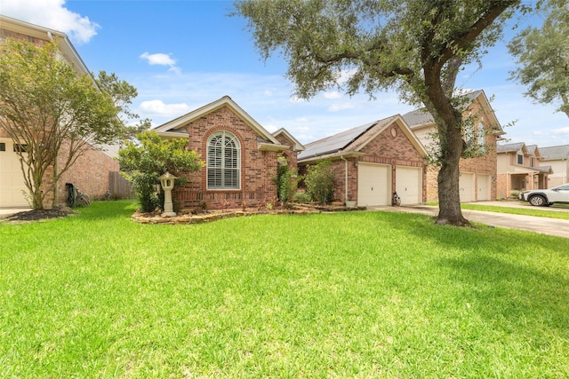 20107 Black Canyon Dr, Katy, TX 77450 - view of front facade featuring driveway, a garage, a front lawn, brick siding, and solar panels
