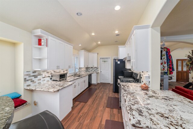 20107 Black Canyon Dr, Katy, TX 77450 - kitchen with a sink, black dishwasher, arched walkways, white cabinetry, and tasteful backsplash