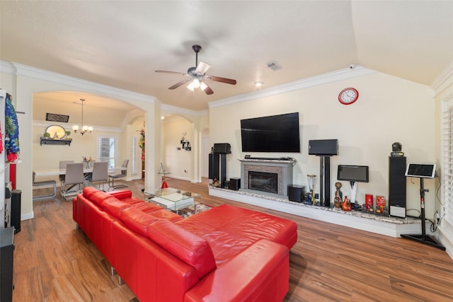 20107 Black Canyon Dr, Katy, TX 77450 - living room with arched walkways, ceiling fan, wood finished floors, crown molding, and a glass covered fireplace