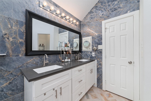 20107 Black Canyon Dr, Katy, TX 77450 - bathroom with lofted ceiling, tile walls, and double vanity