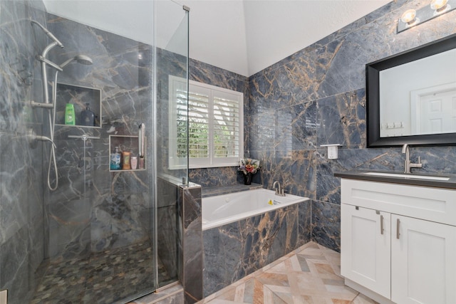 20107 Black Canyon Dr, Katy, TX 77450 - bathroom featuring vanity, a garden tub, a marble finish shower, and tile walls