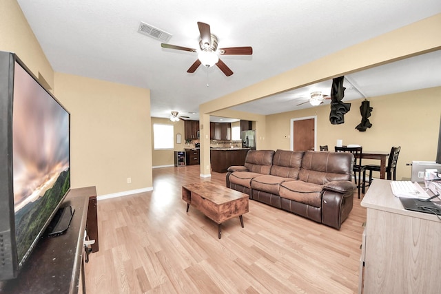 5423 Lillian St, Baytown, TX 77521 - living area featuring ceiling fan, light wood finished floors, and baseboards