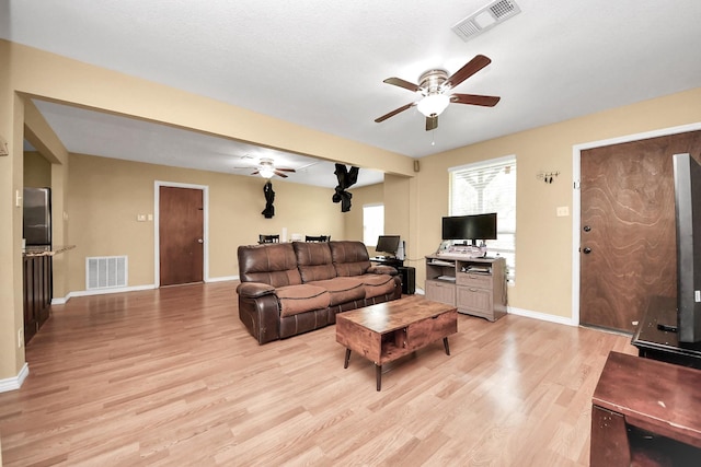 5423 Lillian St, Baytown, TX 77521 - living area featuring a ceiling fan, light wood finished floors, and baseboards