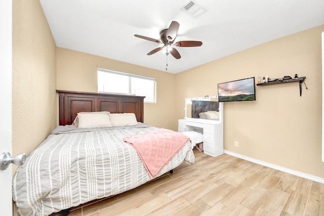 5423 Lillian St, Baytown, TX 77521 - bedroom with baseboards, light wood finished floors, and a ceiling fan