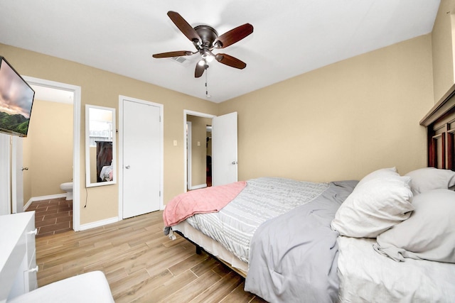 5423 Lillian St, Baytown, TX 77521 - bedroom featuring light wood-style floors, baseboards, ensuite bathroom, and a ceiling fan