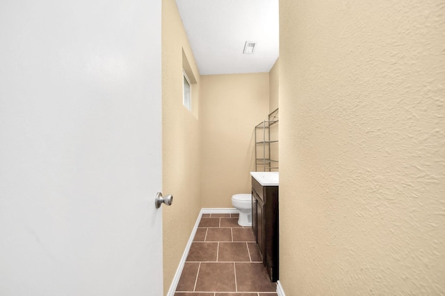 5423 Lillian St, Baytown, TX 77521 - bathroom featuring toilet, tile patterned flooring, vanity, a textured wall, and baseboards