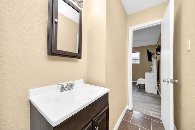 5423 Lillian St, Baytown, TX 77521 - bathroom featuring vanity, tile patterned floors, a textured wall, and baseboards