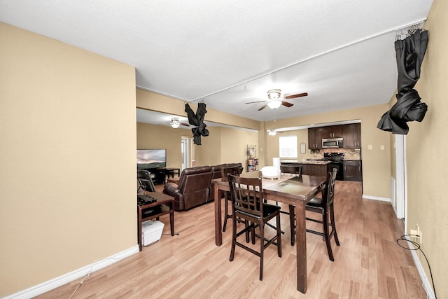 5423 Lillian St, Baytown, TX 77521 - dining area featuring a ceiling fan, light wood-type flooring, and baseboards