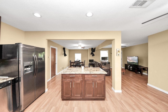 5423 Lillian St, Baytown, TX 77521 - kitchen with stainless steel appliances, light wood-type flooring, open floor plan, light stone countertops, and recessed lighting