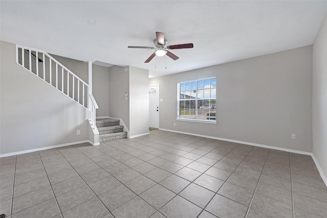 11871 Algonquin Dr, Houston, TX 77089 - unfurnished living room with ceiling fan, stairs, tile patterned flooring, and baseboards