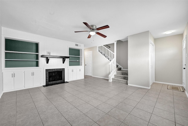 11871 Algonquin Dr, Houston, TX 77089 - unfurnished living room featuring a ceiling fan, baseboards, stairway, tile patterned flooring, and built in shelves