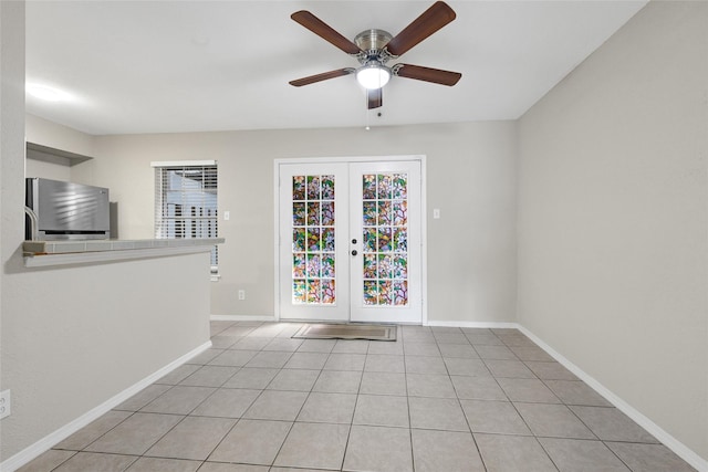 11871 Algonquin Dr, Houston, TX 77089 - empty room with a ceiling fan, french doors, baseboards, and light tile patterned floors