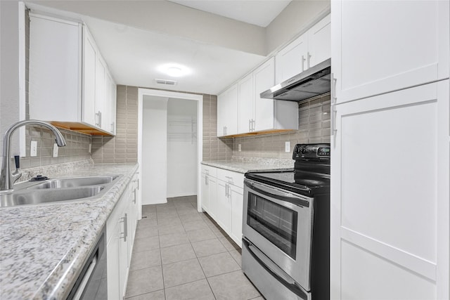 11871 Algonquin Dr, Houston, TX 77089 - kitchen featuring stainless steel range with electric cooktop, a sink, under cabinet range hood, light countertops, and white cabinetry