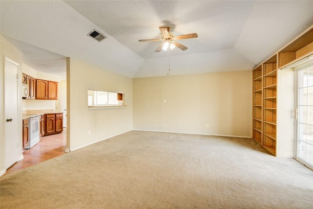 9831 Shell Rock Rd, La Porte, TX 77571 - unfurnished living room featuring light carpet, a ceiling fan, plenty of natural light, baseboards, and vaulted ceiling