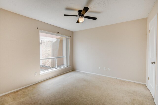 9831 Shell Rock Rd, La Porte, TX 77571 - empty room featuring carpet floors, ceiling fan, and baseboards