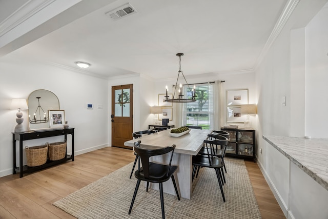 10622 Wickersham Ln, Houston, TX 77042 - dining area featuring a chandelier, light wood-style flooring, ornamental molding, and baseboards
