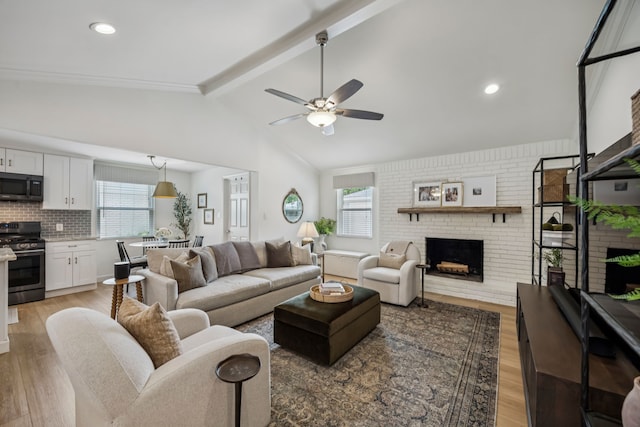 10622 Wickersham Ln, Houston, TX 77042 - living room featuring light wood-style flooring, a ceiling fan, healthy amount of natural light, a fireplace, and recessed lighting