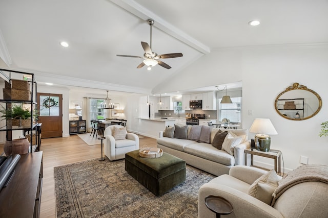 10622 Wickersham Ln, Houston, TX 77042 - living area with a ceiling fan, light wood finished floors, healthy amount of natural light, a chandelier, and ornamental molding