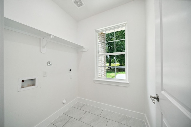 702 Azalea St, Prairie View, TX 77484 - laundry room with hookup for a washing machine, electric dryer hookup, baseboards, gas dryer hookup, and plenty of natural light