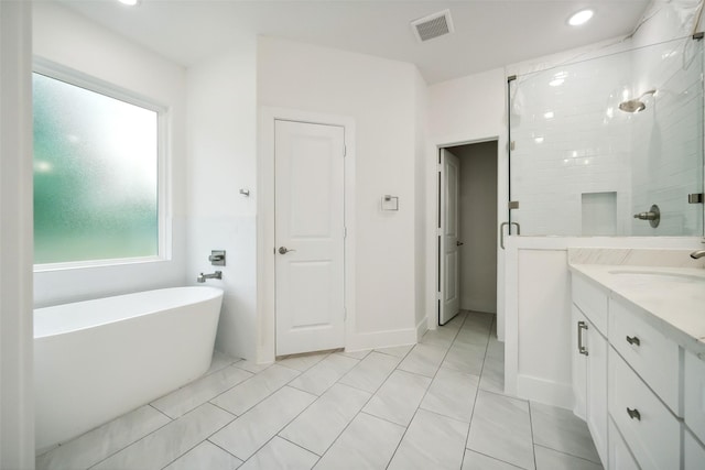 702 Azalea St, Prairie View, TX 77484 - full bath with a soaking tub, vanity, a stall shower, and recessed lighting