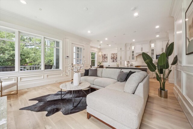 432 Marshall St, Houston, TX 77006 - living area featuring light wood-style floors, recessed lighting, crown molding, and a decorative wall