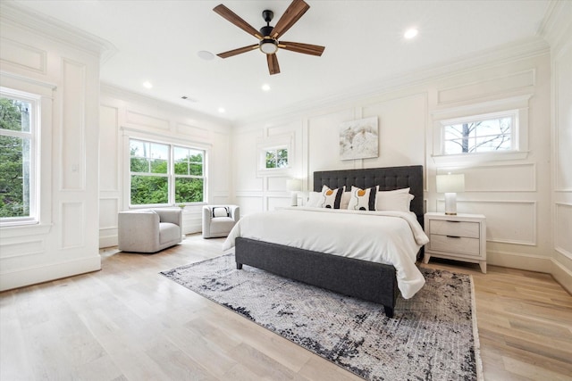 432 Marshall St, Houston, TX 77006 - bedroom with a decorative wall, crown molding, light wood-type flooring, ceiling fan, and recessed lighting