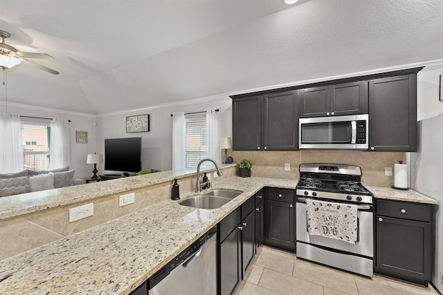 12915 Taper Reach Dr, Tomball, TX 77377 - kitchen featuring stainless steel appliances, a ceiling fan, decorative backsplash, vaulted ceiling, and crown molding