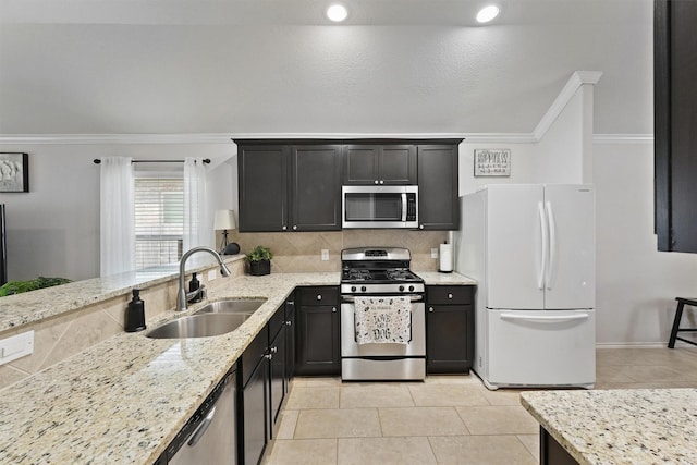 12915 Taper Reach Dr, Tomball, TX 77377 - kitchen with appliances with stainless steel finishes, light tile patterned flooring, light stone countertops, ornamental molding, and tasteful backsplash